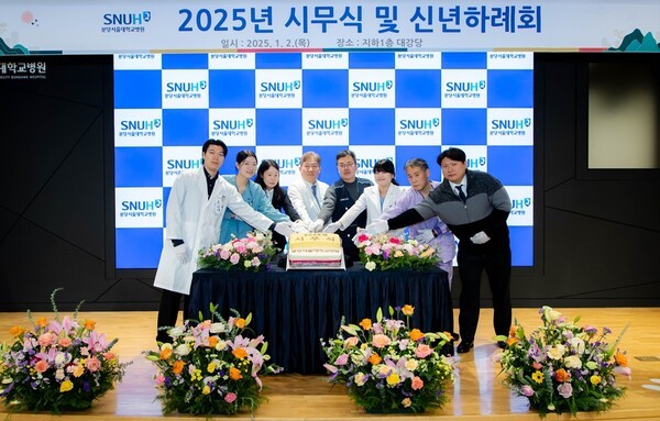 송정한 원장(왼쪽에서 4번째), 박찬경 노조위원장(왼쪽에서 5번째), 출생연도가 뱀띠인 직종별 직원 대표가 커팅식을 진행하고 있다